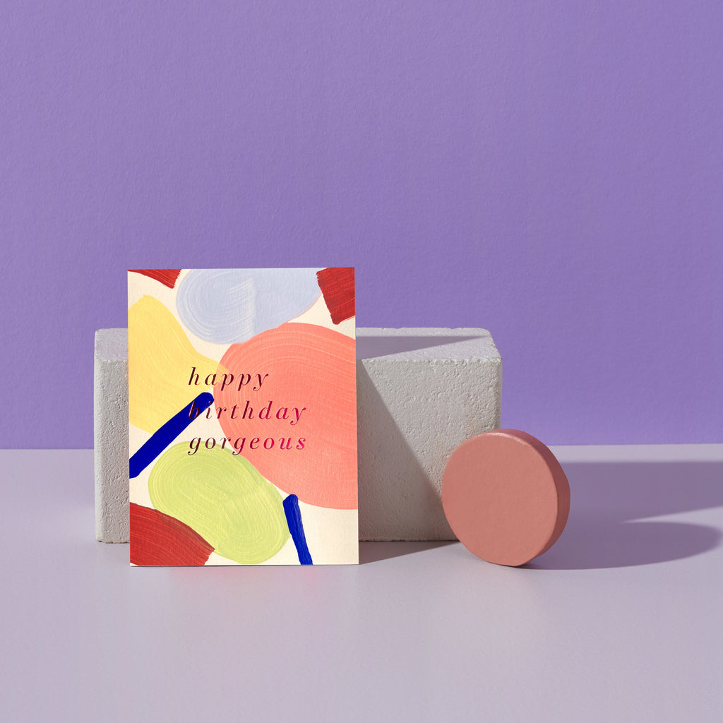 Colorful birthday card with abstract design on a purple background