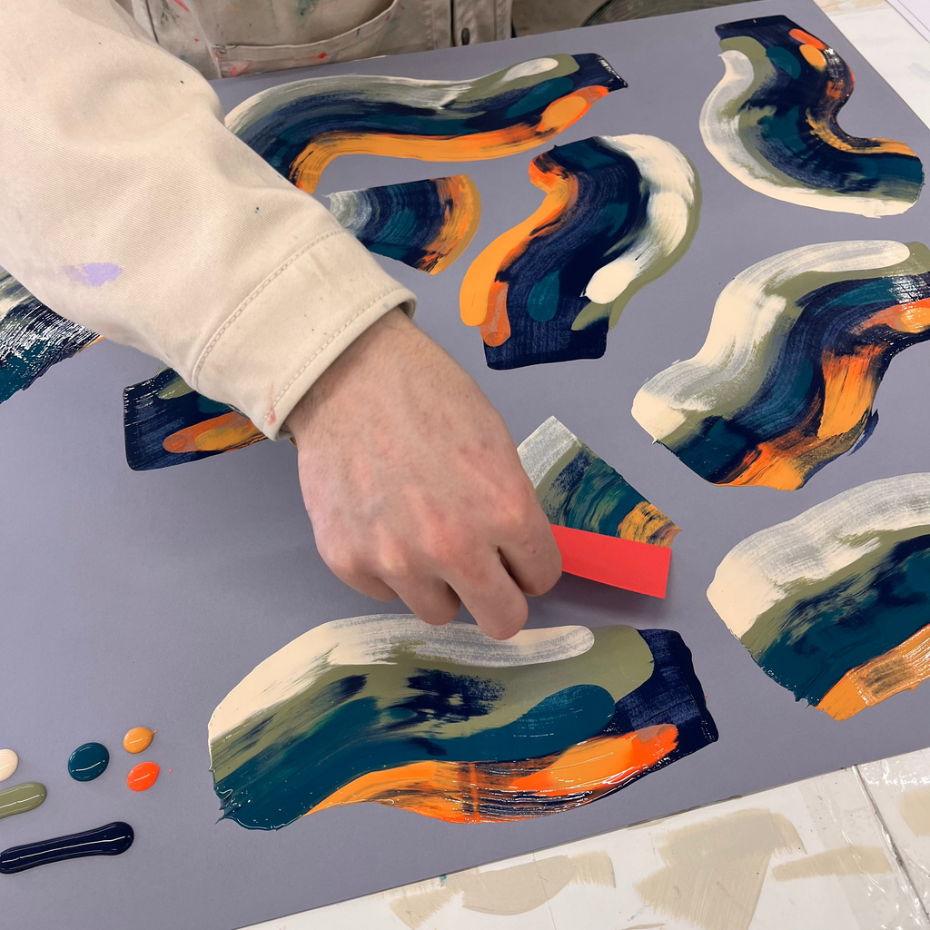 Hand painting colorful abstract swirl art pieces on gray paper