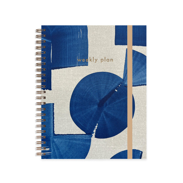 Weekly plan notebook with blue and beige abstract design on a white background